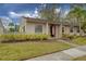 Charming single-story home with an American flag and well-manicured landscaping at 20 Sylvia Pl, Oldsmar, FL 34677