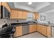 Well-lit kitchen featuring granite countertops, stainless steel appliances, and maple cabinetry at 20 Sylvia Pl, Oldsmar, FL 34677