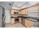 Beautifully designed kitchen with stainless steel appliances, maple cabinets, and elegant countertops at 20 Sylvia Pl, Oldsmar, FL 34677
