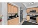Well-lit kitchen with stainless steel appliances and natural wood cabinetry at 20 Sylvia Pl, Oldsmar, FL 34677