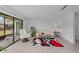 Living area featuring neutral paint, tile flooring, and sliding doors to the screened porch at 20 Sylvia Pl, Oldsmar, FL 34677