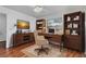 Well-appointed home office with hardwood floors, built-in shelves, and a comfortable workspace at 20 Sylvia Pl, Oldsmar, FL 34677