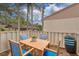 Cozy patio with seating area, perfect for outdoor dining and relaxation under palm trees at 20 Sylvia Pl, Oldsmar, FL 34677