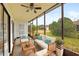 Relaxing screened porch featuring comfortable seating and views of the lush backyard at 20 Sylvia Pl, Oldsmar, FL 34677