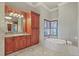 Bathroom features a soaking tub, vanity, and wood trim at 1097 Eden Isle Ne Dr, St Petersburg, FL 33704