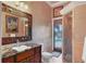 Bathroom boasts a granite countertop vanity, walk-in shower, and waterfront view at 1097 Eden Isle Ne Dr, St Petersburg, FL 33704