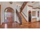 Grand foyer with staircase and detailed woodwork at 1097 Eden Isle Ne Dr, St Petersburg, FL 33704