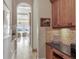 Hallway with travertine flooring and a view to the living room at 1097 Eden Isle Ne Dr, St Petersburg, FL 33704