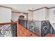 Wide hallway with ornate wrought iron railings and views through the home at 1097 Eden Isle Ne Dr, St Petersburg, FL 33704