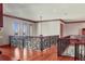 Spacious hallway with intricate wrought iron railings and beautiful hardwood floors at 1097 Eden Isle Ne Dr, St Petersburg, FL 33704