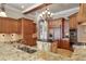 Spacious kitchen boasts a center island, custom cabinetry, and granite countertops at 1097 Eden Isle Ne Dr, St Petersburg, FL 33704