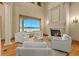 Living room showcasing a stone fireplace, water views, and elegant seating arrangement at 1097 Eden Isle Ne Dr, St Petersburg, FL 33704
