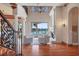 Elegant living room with fireplace, hardwood floors, and waterfront view at 1097 Eden Isle Ne Dr, St Petersburg, FL 33704