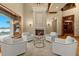 Inviting living room featuring a cozy fireplace and waterfront views, perfect for relaxation at 1097 Eden Isle Ne Dr, St Petersburg, FL 33704