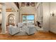 Grand living room with a fireplace, large windows offering waterfront views, and sophisticated furnishings at 1097 Eden Isle Ne Dr, St Petersburg, FL 33704
