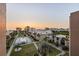 Aerial view of the community, showing the pool and well-maintained grounds at sunset at 19725 Gulf Blvd # 405, Indian Shores, FL 33785