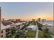 Aerial view of community with pool and landscaping during sunset at 19725 Gulf Blvd # 405, Indian Shores, FL 33785