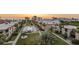 Sunset aerial view of the community showcasing pool, landscaping, and surrounding buildings at 19725 Gulf Blvd # 405, Indian Shores, FL 33785