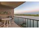 Balcony with table, chairs, and a view of the waterway and greenery at 19725 Gulf Blvd # 405, Indian Shores, FL 33785