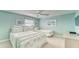 Bright bedroom featuring ceiling fan, two beds, and neutral decor at 19725 Gulf Blvd # 405, Indian Shores, FL 33785