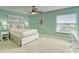 Bright bedroom with large windows, a ceiling fan, and calming green walls at 19725 Gulf Blvd # 405, Indian Shores, FL 33785