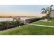 Dock on the water with a picnic table and palm trees at 19725 Gulf Blvd # 405, Indian Shores, FL 33785