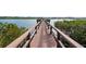 Community pier with wood plank flooring and lush vegetation at 19725 Gulf Blvd # 405, Indian Shores, FL 33785