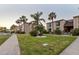 Exterior view of a building with manicured lawn and landscaping at 19725 Gulf Blvd # 405, Indian Shores, FL 33785