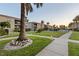 A condo exterior with palm trees, manicured lawn, walkways and shared amenities at 19725 Gulf Blvd # 405, Indian Shores, FL 33785