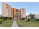 Exterior of a condo building with well-maintained landscaping and manicured lawn at 19725 Gulf Blvd # 405, Indian Shores, FL 33785