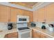 Updated kitchen with ample counter space, modern appliances, and wood-style cabinets at 19725 Gulf Blvd # 405, Indian Shores, FL 33785