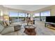 Relax in this inviting living room with a balcony and expansive water views through the sliding glass doors at 19725 Gulf Blvd # 405, Indian Shores, FL 33785