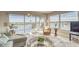 Relax in this inviting living room with a balcony and expansive water views through the sliding glass doors at 19725 Gulf Blvd # 405, Indian Shores, FL 33785