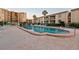 A spacious community pool with ample seating and surrounding apartment buildings at 19725 Gulf Blvd # 405, Indian Shores, FL 33785