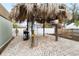Backyard entertainment area features a unique tiki structure with an outdoor TV, ideal for relaxation and hosting guests at 210 Lee St, Oldsmar, FL 34677