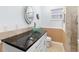 Bathroom featuring vessel sink on granite counters and tiled shower at 210 Lee St, Oldsmar, FL 34677