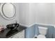 Stylish half bathroom featuring sleek vessel sink and modern fixtures at 210 Lee St, Oldsmar, FL 34677