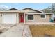 Charming home with a red front door, garage, and well-maintained lawn, offering a welcoming curb appeal at 210 Lee St, Oldsmar, FL 34677