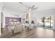 Open-concept living room with a fireplace, modern decor, and sliding glass doors to the backyard at 210 Lee St, Oldsmar, FL 34677