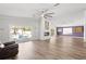 Open living room featuring hardwood floors, a fireplace, a view of the pool, and sliding glass doors at 210 Lee St, Oldsmar, FL 34677