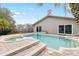 Backyard pool and spa surrounded by brick pavers and lush landscaping at 210 Lee St, Oldsmar, FL 34677