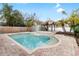 Backyard oasis featuring a refreshing pool, spa and tiki hut perfect for outdoor entertaining and relaxation at 210 Lee St, Oldsmar, FL 34677