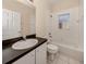 Full bathroom with a combination tub and shower, a dark vanity, and a white toilet at 24156 Buckingham Way, Punta Gorda, FL 33980