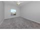 This is a bedroom offering neutral walls, carpeted floor, and natural light from the exterior window at 24156 Buckingham Way, Punta Gorda, FL 33980