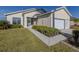 Charming single-story home featuring a well-manicured lawn and an attached two-car garage at 24156 Buckingham Way, Punta Gorda, FL 33980