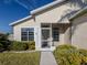 Charming front entrance with a screened-in porch, mature landscaping, and walkway at 24156 Buckingham Way, Punta Gorda, FL 33980