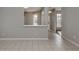 Neutral living area featuring tiled flooring, a breakfast bar, and a view into the hallway at 24156 Buckingham Way, Punta Gorda, FL 33980
