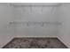 Spacious walk-in closet with neutral carpet and multiple wire shelves for optimal organization at 24156 Buckingham Way, Punta Gorda, FL 33980