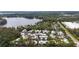 A serene aerial view of community homes nestled alongside a beautiful lake with lush green surroundings at 3406 Waterbridge Dr, Tampa, FL 33618