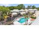 Community pool with sundeck and lounge chairs surrounded by lush landscaping and well-maintained townhomes at 3406 Waterbridge Dr, Tampa, FL 33618